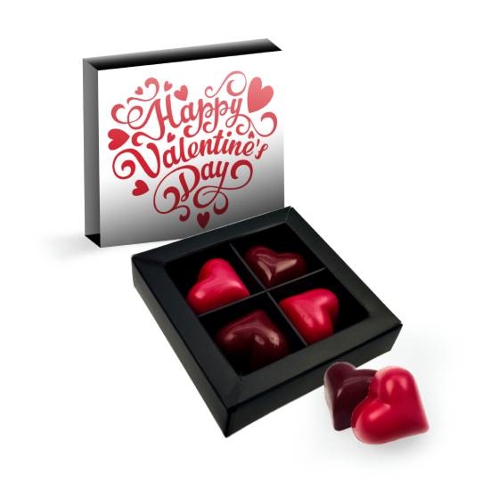 4 handmade chocolates in a box with a sash