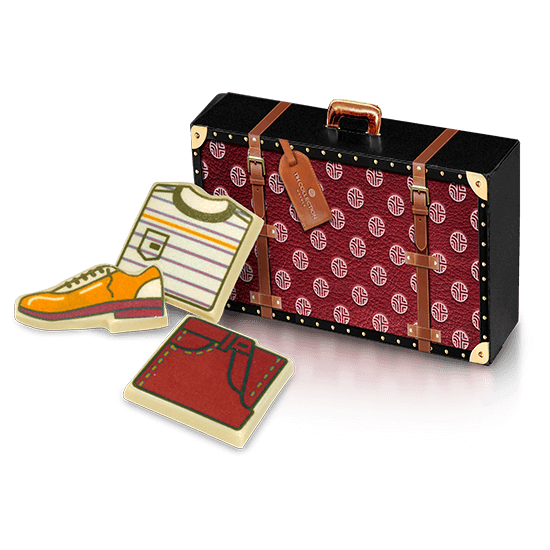 Cardboard suitcase with pieces of chocolate
